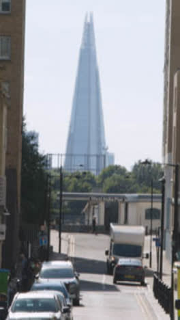 Vertical-Video-Of-View-Along-London-Docklands-Street-Towards-The-Shard-UK